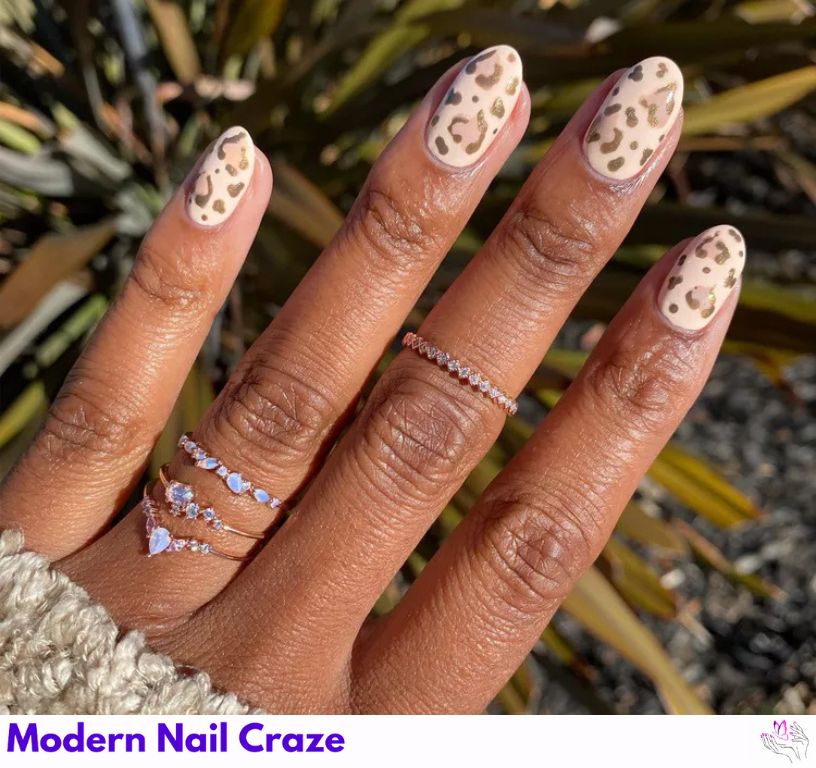 Minimal muted cheetah spots on a soft nude base for short nails.