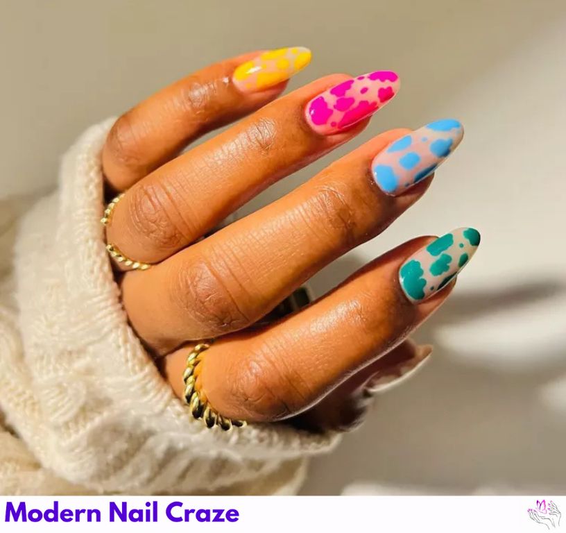 Neon cow print nail design on short, rounded nails, bold and fun.