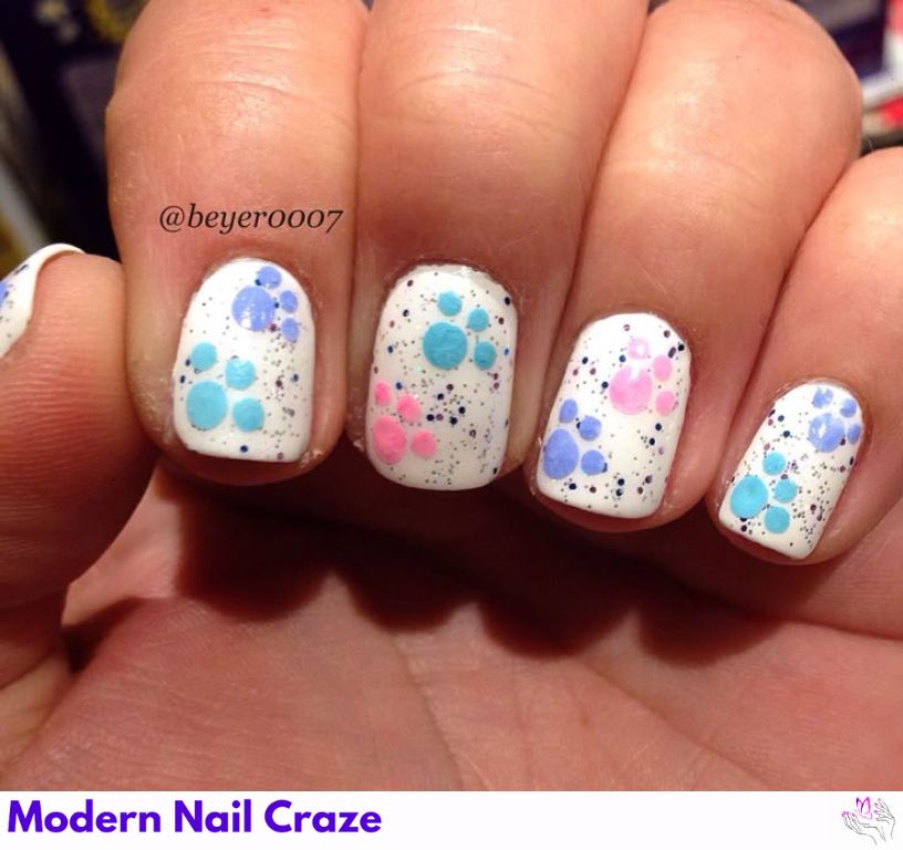 Pastel nails with tiny black dog paw print details.