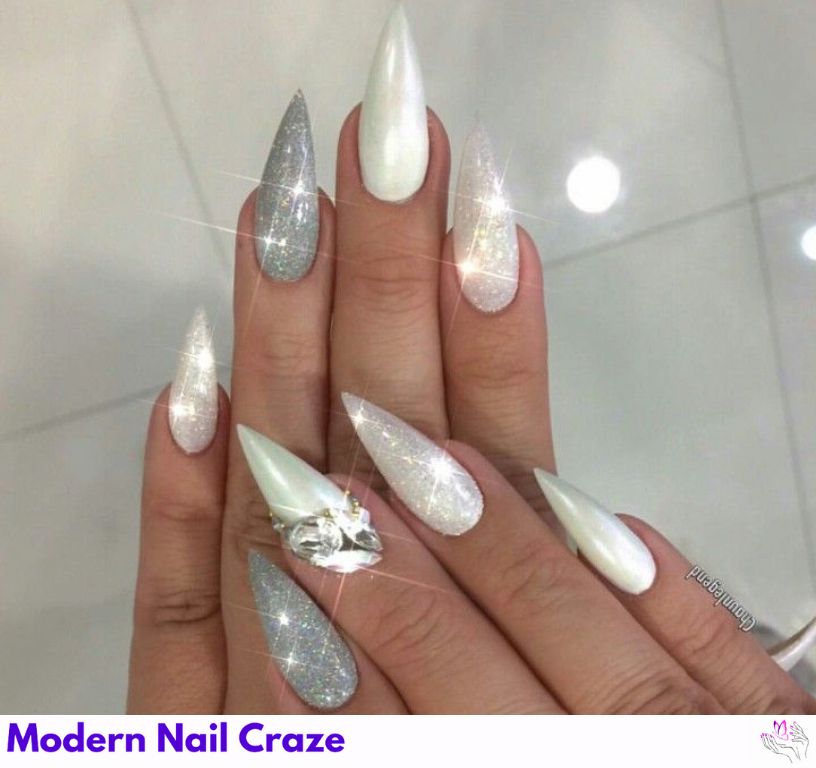 Pearl white stiletto nails glowing under light, perfect for classic brides.