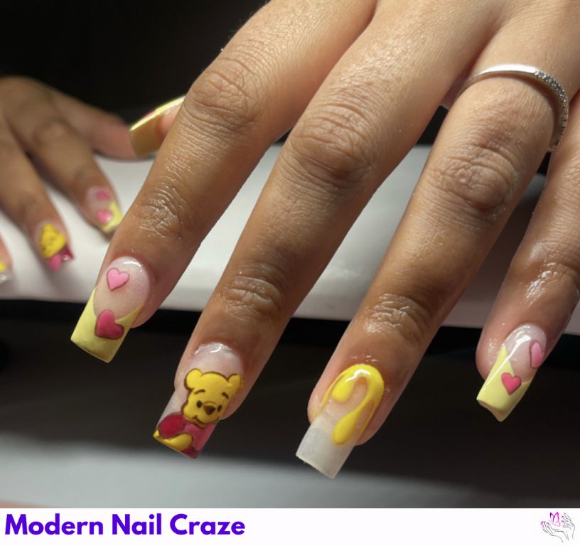 Glittery Pooh Acrylic Nails – Sparkling acrylic nails with embedded decals and gold foil.