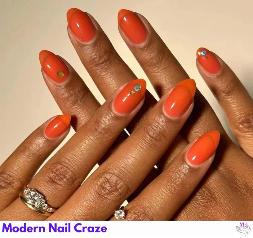 Burnt orange jelly nails with glitter embedded for a shiny, layered effect.