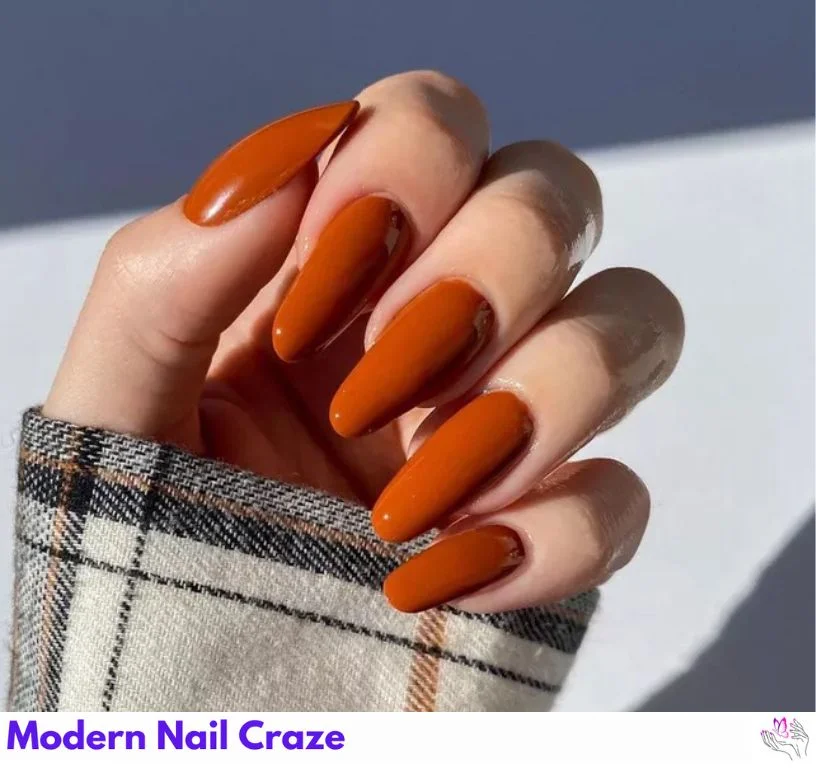 Soft sienna solid-color nails with minimal negative space accent.
