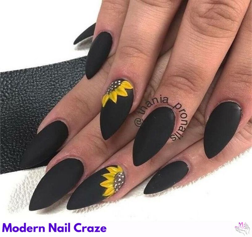 Bold sunflower nail art on a matte black base for striking contrast
