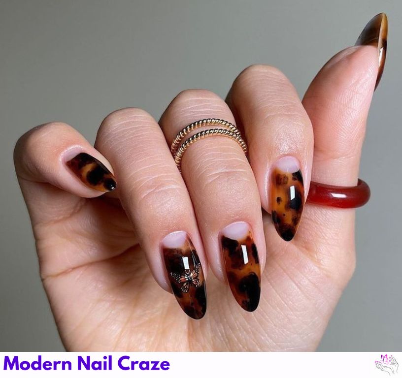 Elegant half-moon tortoiseshell nail design on a natural base.