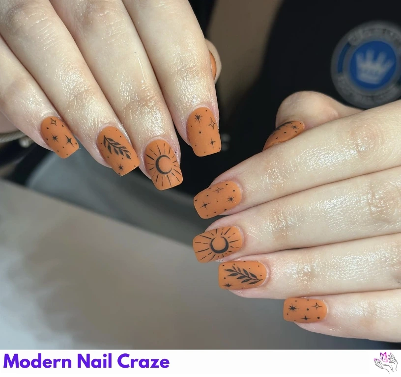 Celestial burnt orange nail art with golden stars and moons — astrology inspired.