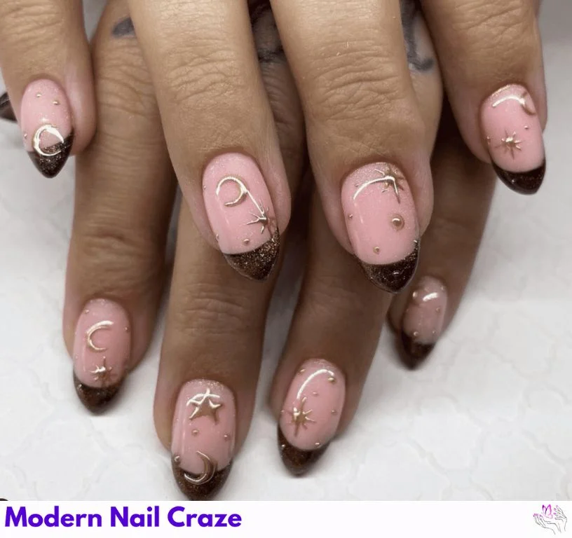 Pastel pink nails with golden accents and hand-drawn stars