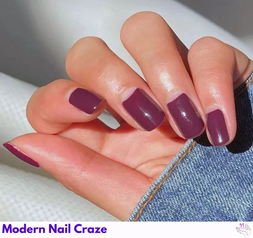 Dark purple manicure with negative space half-moon