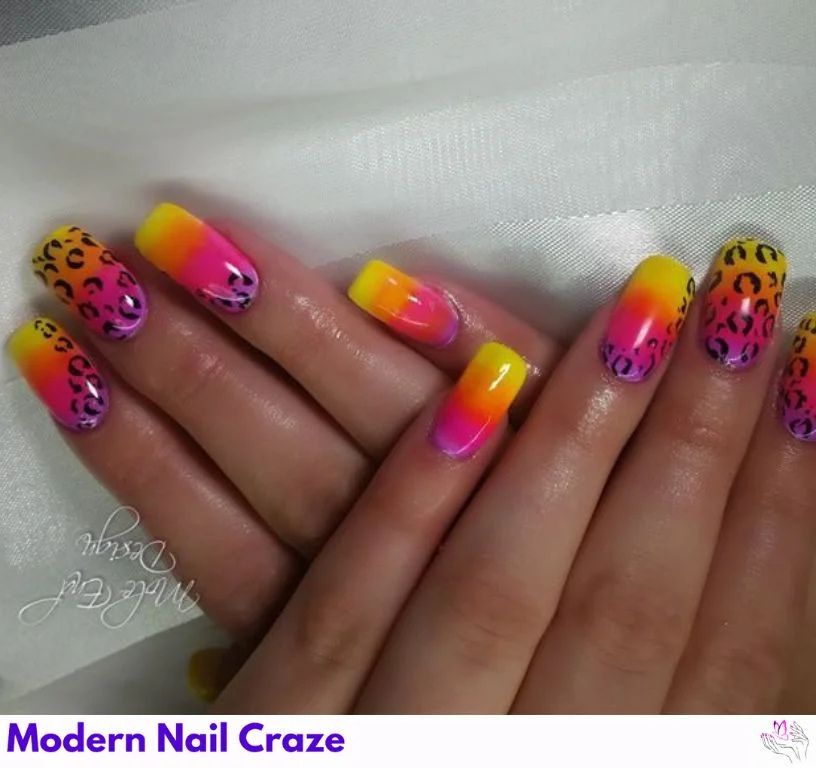 Close-up of tribal safari nail designs with bright neon green, pink, and orange patterns for high-impact fashion-forward flair.