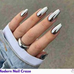 Futuristic chrome and metallic nails reflecting light in silver and gold hues.
